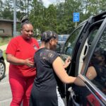 IMG_5129 DSP assists IDD resident with transportation and safely getting into the car.