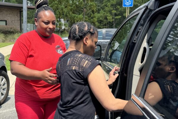 DSP assists IDD resident with transportation and safely getting into the car.